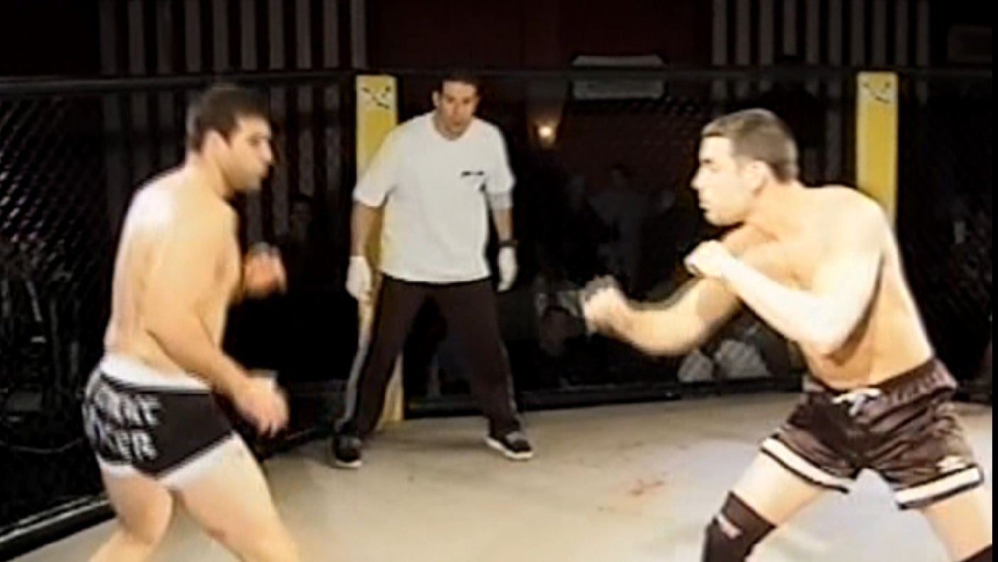 Scott Tannenbaum squaring up with an opponent in an early cage fight